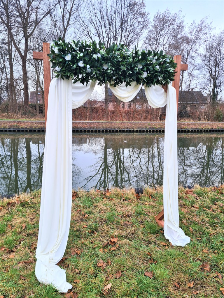 vooraanzicht White Dreams trouwboog met wit groen thema & mooie witte afwerking.